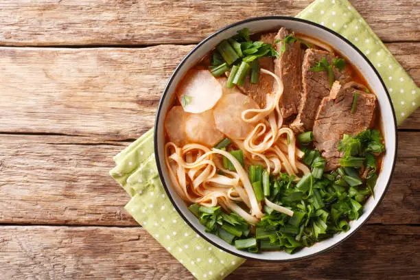 Easy Recipe for Lanzhou Beef Noodle Soup closeup in a bowl on the table. horizontal top view from above