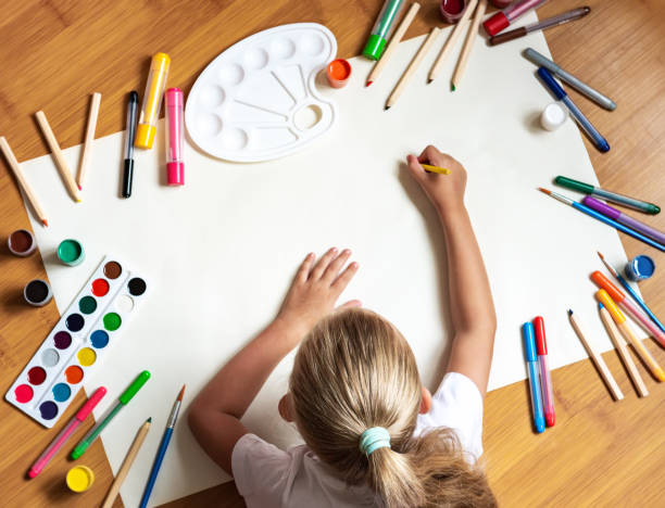 istock Little girl drawing in paper 1168029344