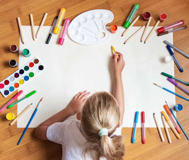 istock Little girl drawing in paper 1168029349