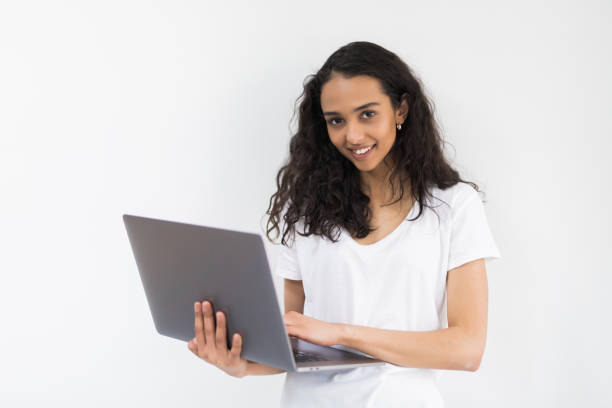 istock Thoughtful young woman using laptop on white background 1168029901
