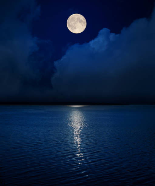 istock full moon in dark sky over clouds and water in river 1168031065