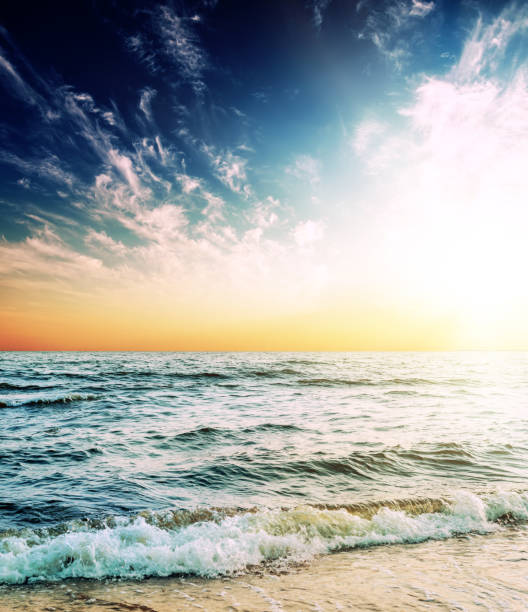 istock dark sky with orange sunset over sea 1168031229