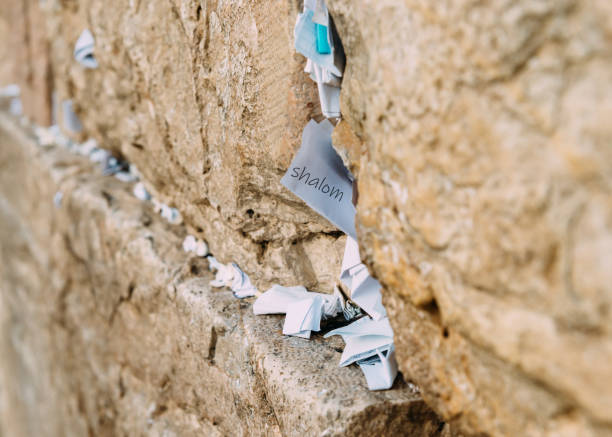 Notes on the wailing (Western) wall in Jerusalem Israel Notes on the wailing (Western) wall in Jerusalem Israel. Shalom written on one of the notes, which means peace in Hebrew wailing wall stock pictures, royalty-free photos & images