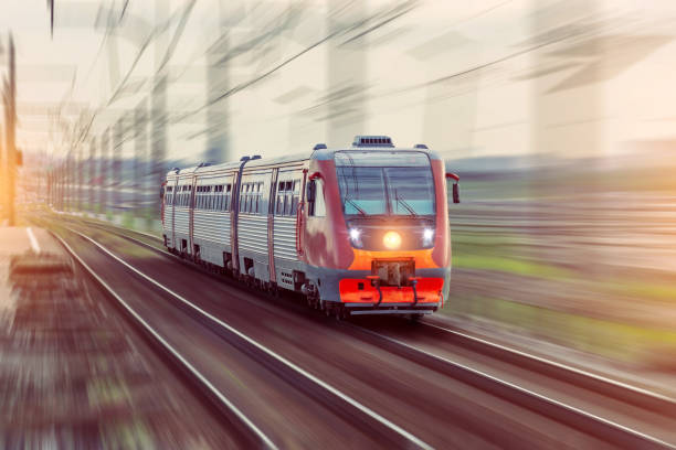 istock Passenger diesel train travels by rail motion blur effect. 1168033866