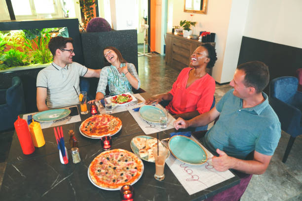 istock Friends Enjoying In Restaurant 1168034052