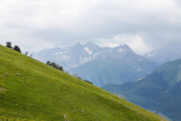 istock green slope of a high mountain during a thunderstorm with clouds 1168035448