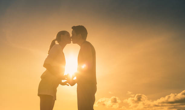 istock Young couple kissing at sunset. 1168035465