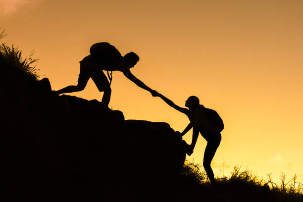 istock Hikers climbing up mountain hill 1168035472