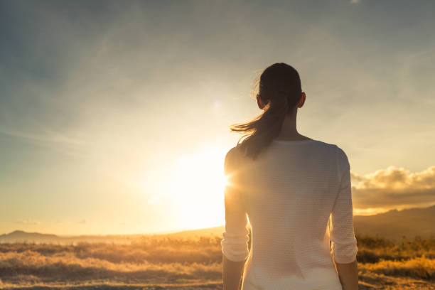 istock Young thoughtful female facing beautiful sunset. 1168035529