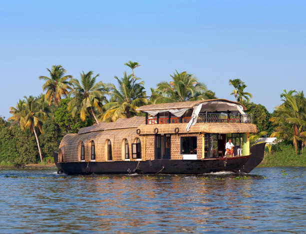 Young attractive girl having a traditional straw houseboat ride on the backwaters of Kerala, India
