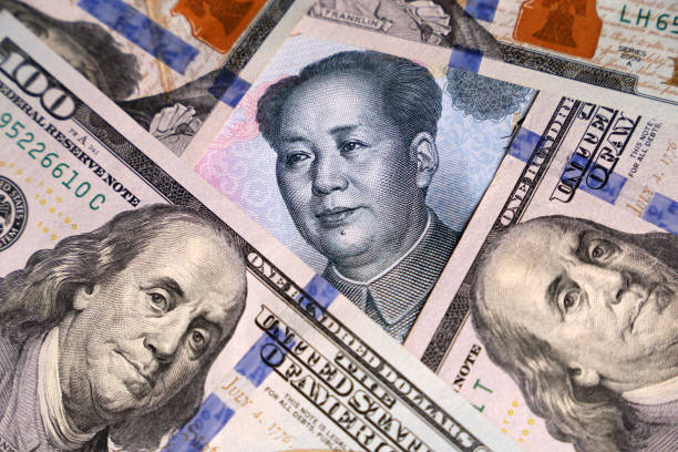 istock US dollars and chinese yuan banknote 1168038015