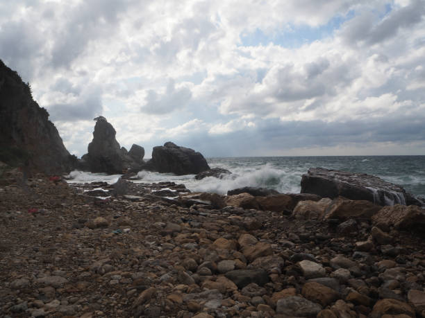 istock Waves hitting the cliffs on the beach in windy and cloudy weather in Amasra 1168039841