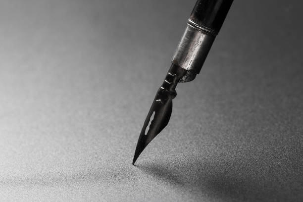istock Old fountain pen on a black textured background 1168039857