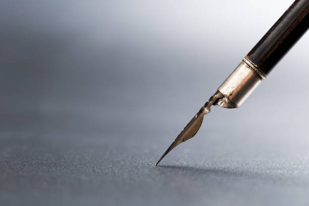 istock Old fountain pen on a black textured background 1168039862