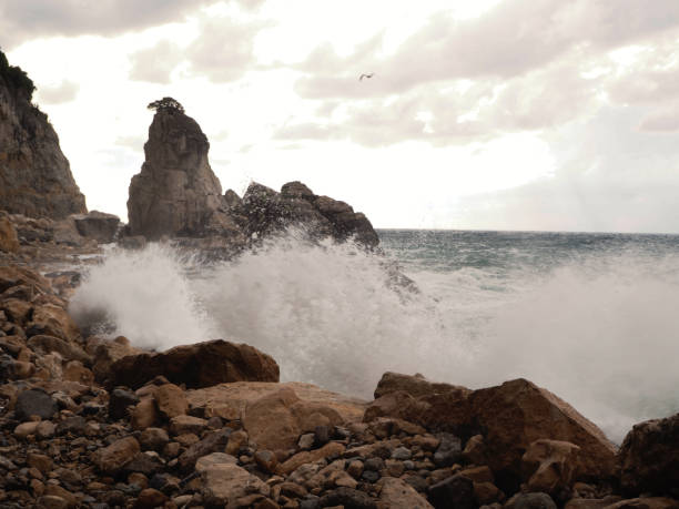 istock Waves hitting the cliffs on the beach in windy and cloudy weather in Amasra 1168040017