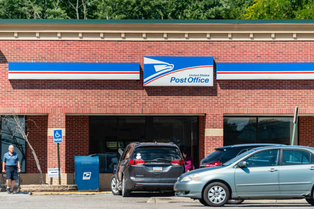 United States Post Office People in front of the United States Post Office on Rochester Road in Rochester Hills, Michigan. The US Postal Service was founded in 1775 with Benjamin Franklin as its first postmaster and today employs almost 600,000 people. united states postal service photos stock pictures, royalty-free photos & images