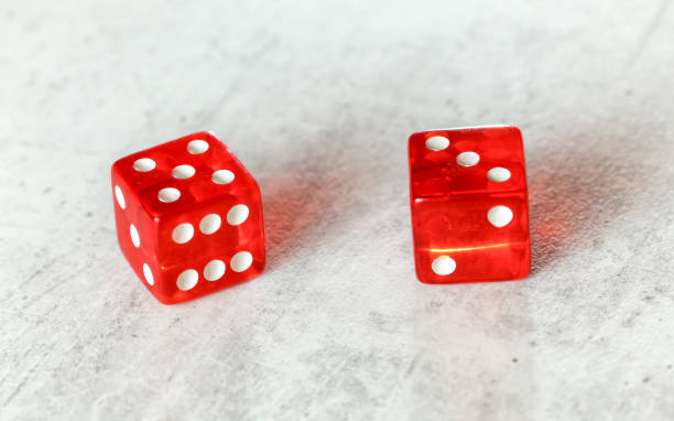 istock Two translucent red craps dices on white board showing Easy Eight number 5 and 3 1168043483
