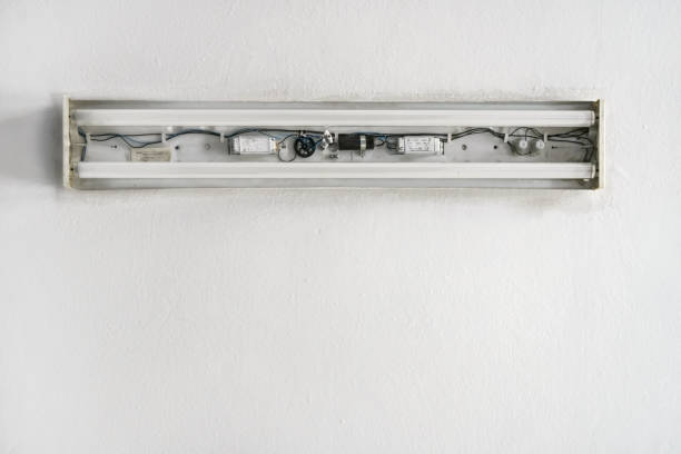 istock Looking up white ceiling in room, old neon lamp with no cover, cables and inside tubes visible 1168044838