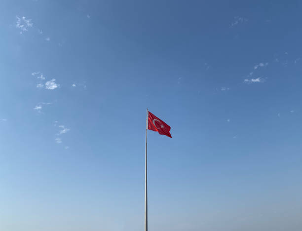 istock Turkish Flag Waves on Clear Sunny Partly Cloudy Weather Background 1168046034