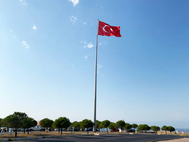 istock Turkish Flag Waves on Clear Sunny Partly Cloudy Weather Background 1168046076