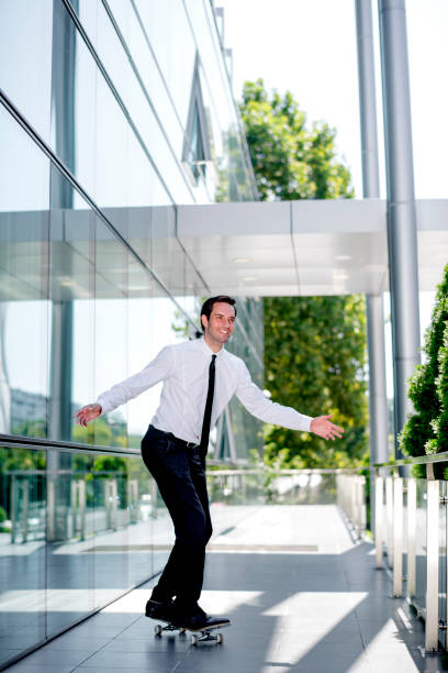 istock Handsome businessman riding skateboard 1168051350