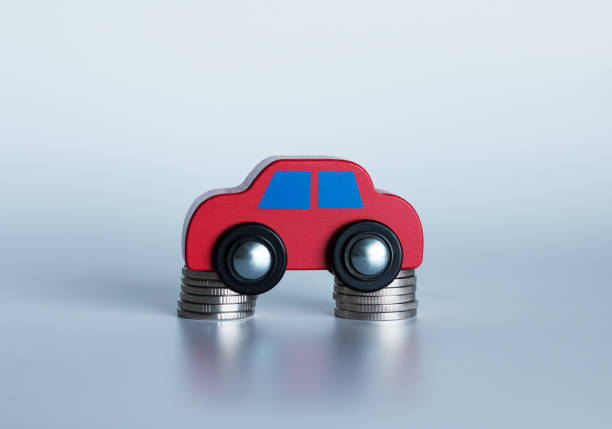 istock A small car is standing on coins 1168052531