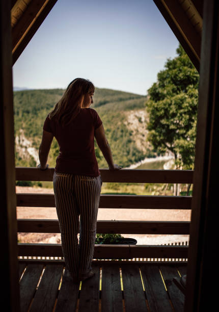 istock Woman on the balcony over the river 1168052755