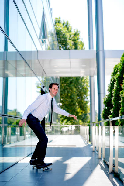 istock Stylish manager riding a skateboard 1168053043