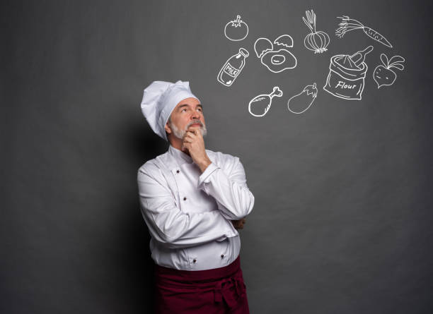 istock Image of chef planing what to cook on gray background.Chef thinking. 1168054167