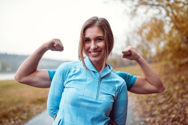 istock Boyfriend Showing Muscles Behind Girlfriend 1168054326
