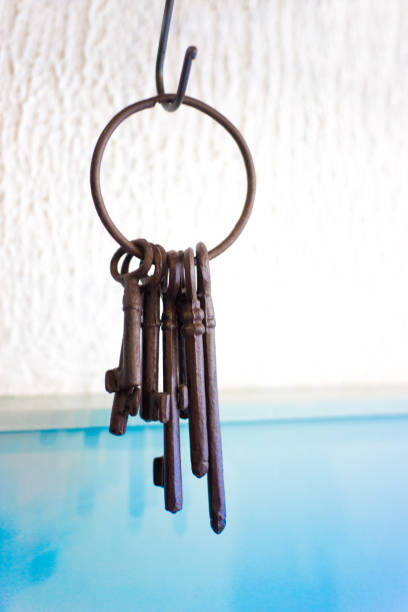 Antique Keys on Ring, Hanging on Blue and White Wall Antique Keys on Ring, Hanging on Blue and White Wall. Copy space available. hook of holland stock pictures, royalty-free photos & images