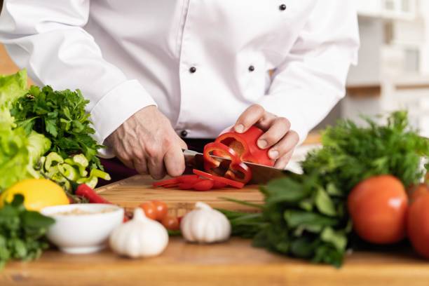 istock Chef cutting fresh and delicious vegetables for cooking. 1168055763