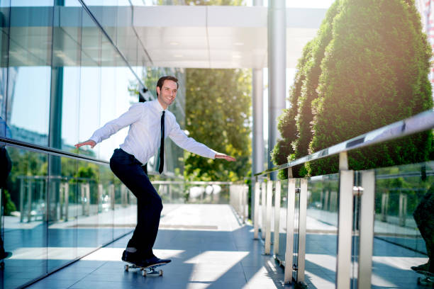 istock Handsome businessman riding skateboard 1168056330