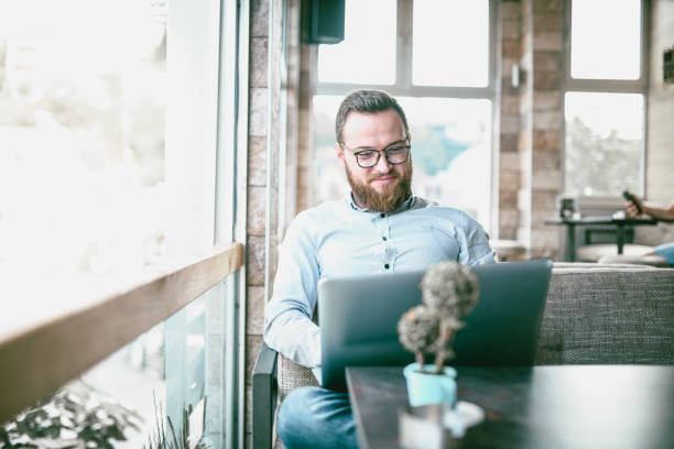 Male Businessman Relaxing In Coffee Bar