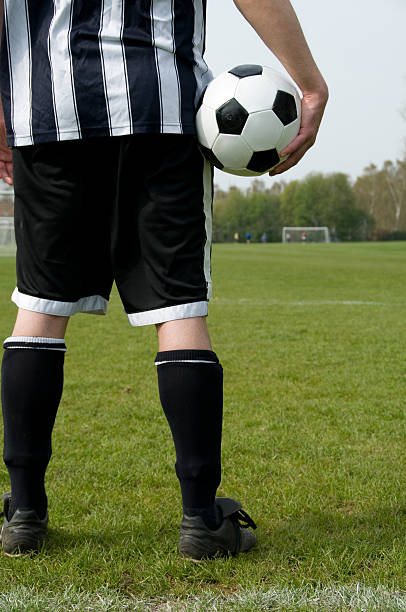 istock Soccer player holds a ball and waits for kick off 116805899