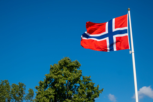 Norway  flags against vibrant blue sky