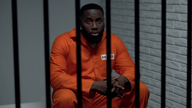 istock Frightened black prisoner sitting in cell, human rights protection, imprisonment 1168059660