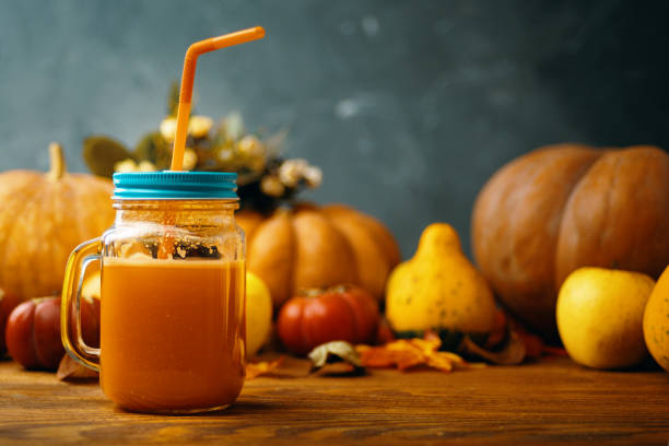 istock Pumpkins juice in bottles with pumpkins. 1168064080
