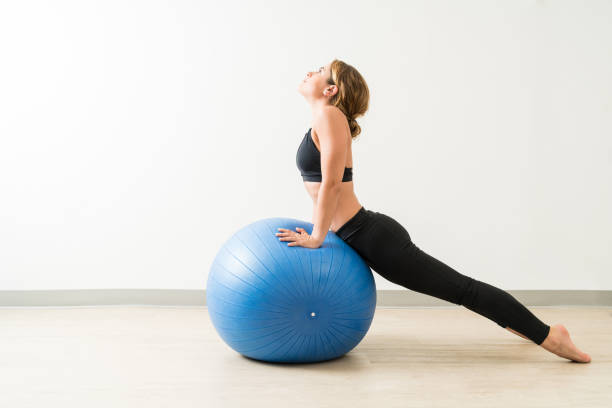 istock Side View Of Young Woman Stretching During Workout 1168064373