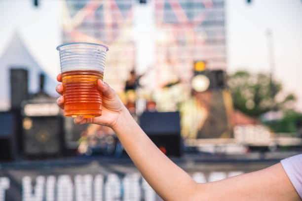 Woman hang holding beer.