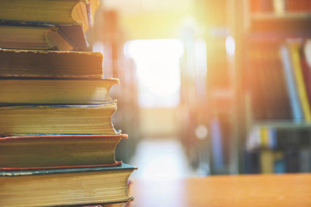 istock book stacked in library - education concept back to school and business study with old books on a wooden table 1168073575