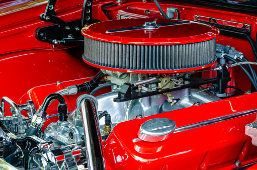 Quarter view of a streetrod engine with red air filter, valve covers and engine compartment