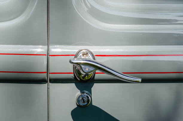 Close-up of a vintage gray car's door handle and door lock with red pinstripes Close-up of a vintage gray car's door handle and door lock with red pinstripes cruising hot rods stock pictures, royalty-free photos & images