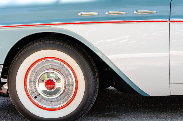 Close-up of a horizontal pinstripe on chrome trim and matching coloring on a vintage car's wheel Close-up of a horizontal pinstripe on chrome trim and matching coloring on a vintage car's wheel cruising hot rods stock pictures, royalty-free photos & images