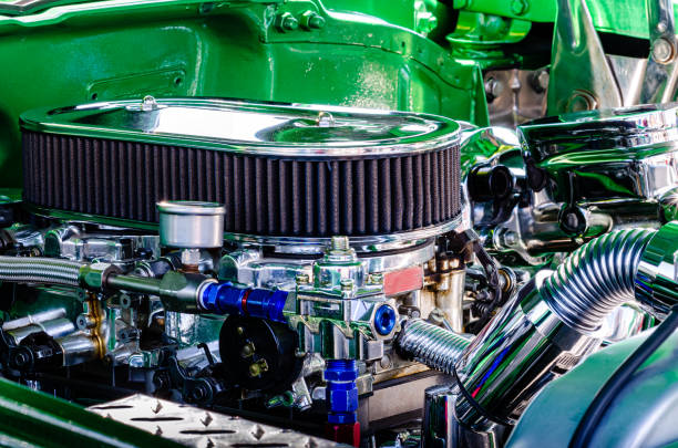 Close-up right side view of a hot rod engine with two carburetors in a green engine compartment Close-up right side view of a hot rod engine with two carburetors in a green engine compartment cruising hot rods stock pictures, royalty-free photos & images