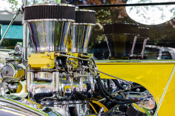 Close-up of a chromed  engine with dual carburetors in a yellow hot rod Close-up of a chromed  engine with dual carburetors in a yellow hot rod cruising hot rods stock pictures, royalty-free photos & images