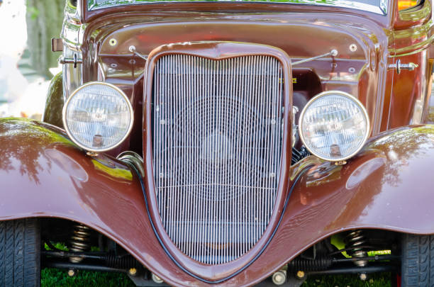 Close-up frontal view of a brown antique hot rod's grill, headlights,fenders and suspension Close-up frontal view of a brown antique hot rod's grill, headlights,fenders and suspension cruising hot rods stock pictures, royalty-free photos & images