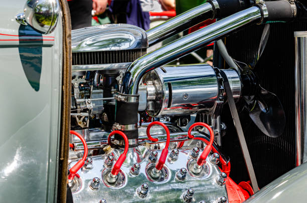 Close-up of a vintage flathead engine with red sparkplug wires in a restored hot rod. Close-up of a vintage flathead engine with red sparkplug wires in a restored hot rod. cruising hot rods stock pictures, royalty-free photos & images