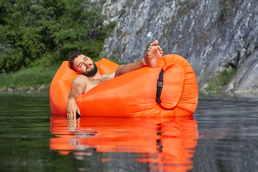 A young businessman, during his vacation, fell asleep in an inflatable lounger and drifting along the river, lowering his hand with the phone into the water, the phone got wet and broke.