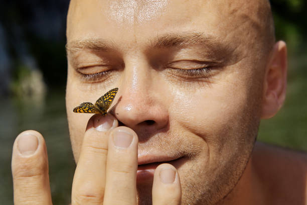 istock Butterfly has flied on the man's nose. 1168073945